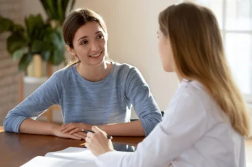 A client talks with a provider about data for their behavioral healthcare.
