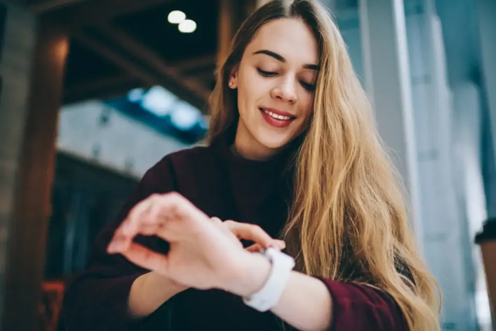 A person uses a smartwatch to track her mood.
