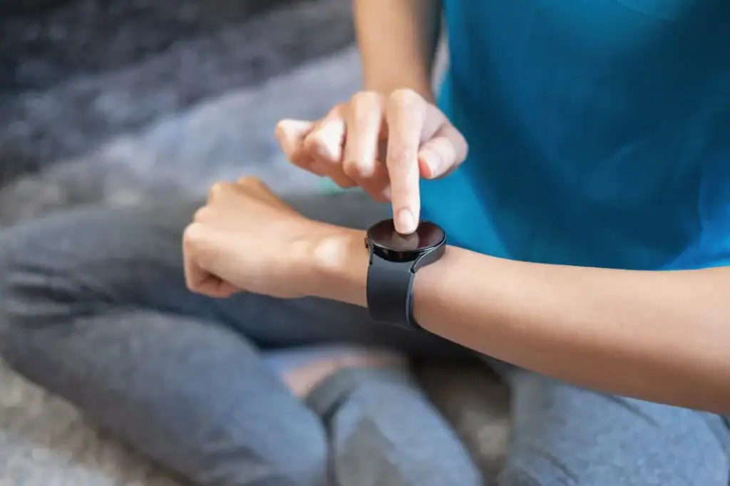A person uses a mental health wearable.